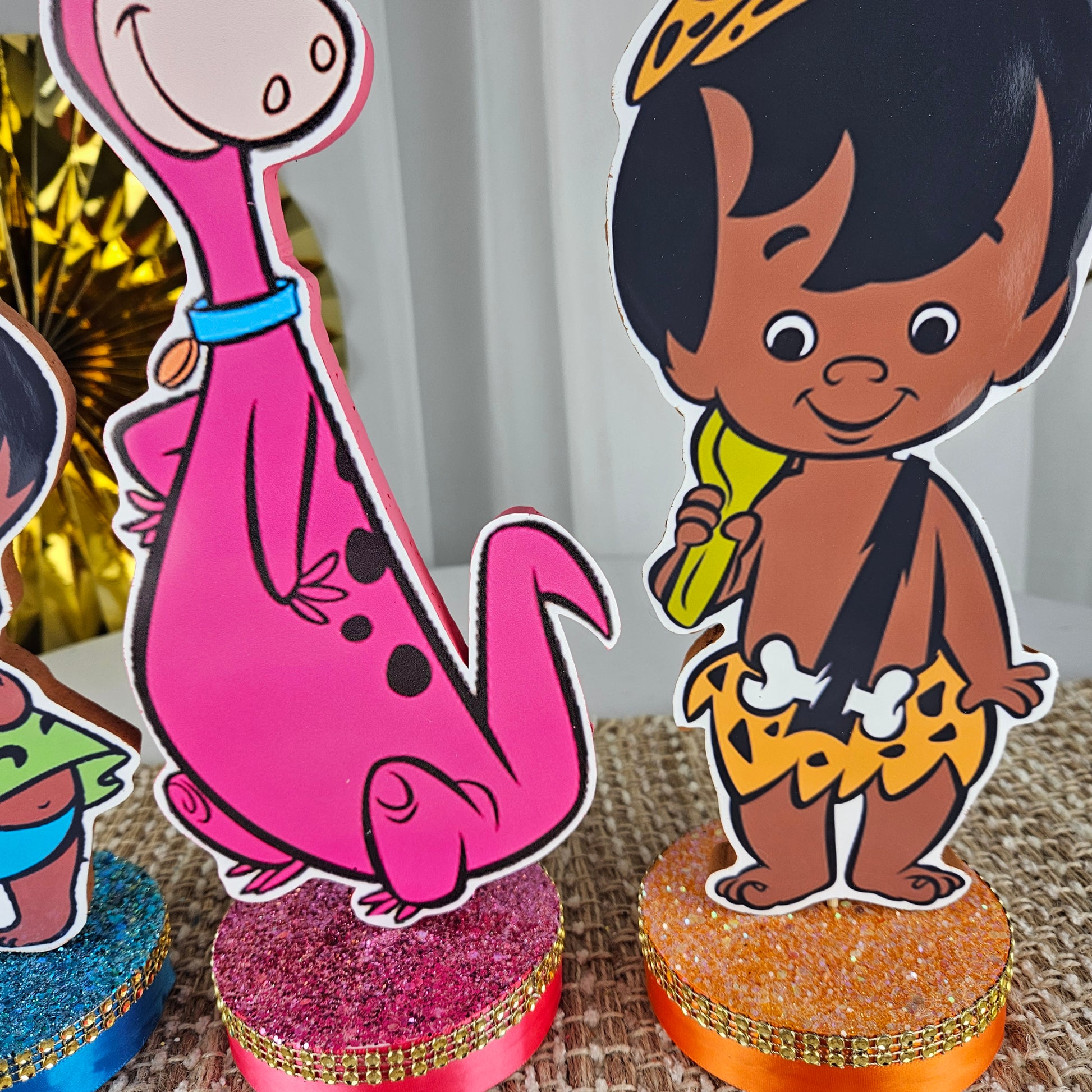 Flintstones themed party decorations with African American Bam Bam and Pebbles