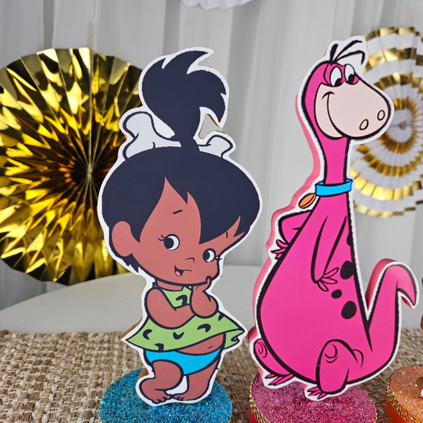 Cute Flintstones character cutouts on decorated foam bases