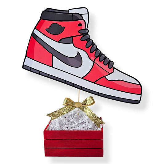 Air Jordan 1 sneaker centerpiece with wooden base, crinkle paper filler, and bow decoration birthday party decoration