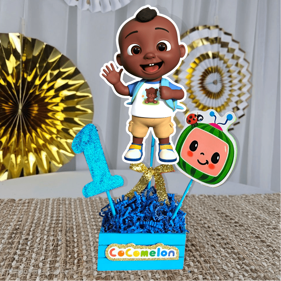 Handmade Cocomelon centerpiece with Afro-American JJ, wooden base, crinkle paper, and personalized birthday sign.