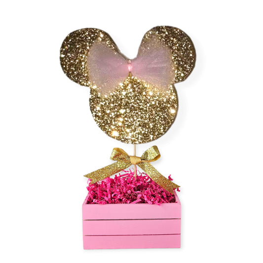 Minnie Mouse head birthday centerpiece made of painted foam with glitter details and ribbon base ready to display