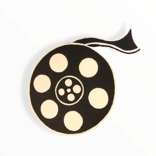 Vintage movie tape cutout prop for retro Hollywood-themed party or quinceañera decor

